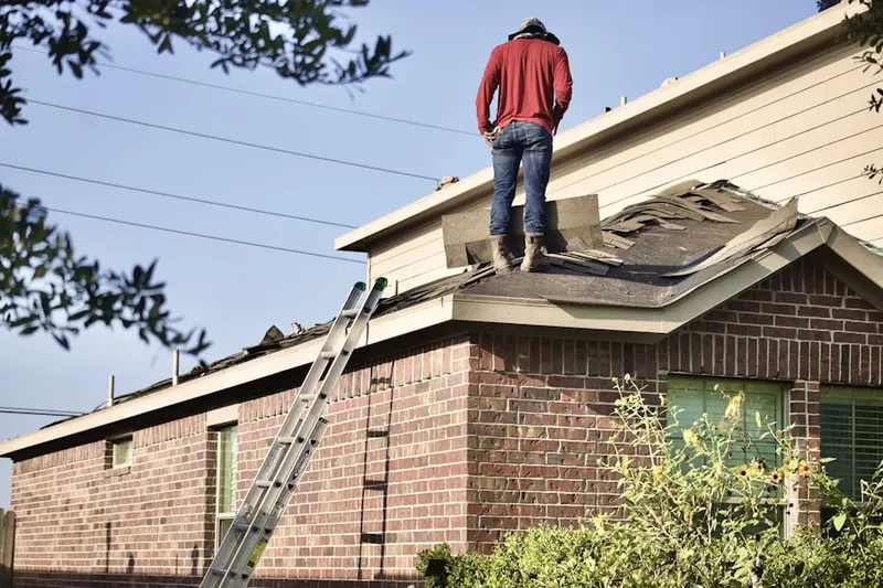 Professional roofer working on a residential roof in Saint James